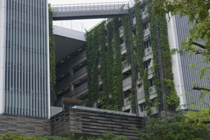 Bangunan modern dengan taman hijau vertikal dan jembatan langit